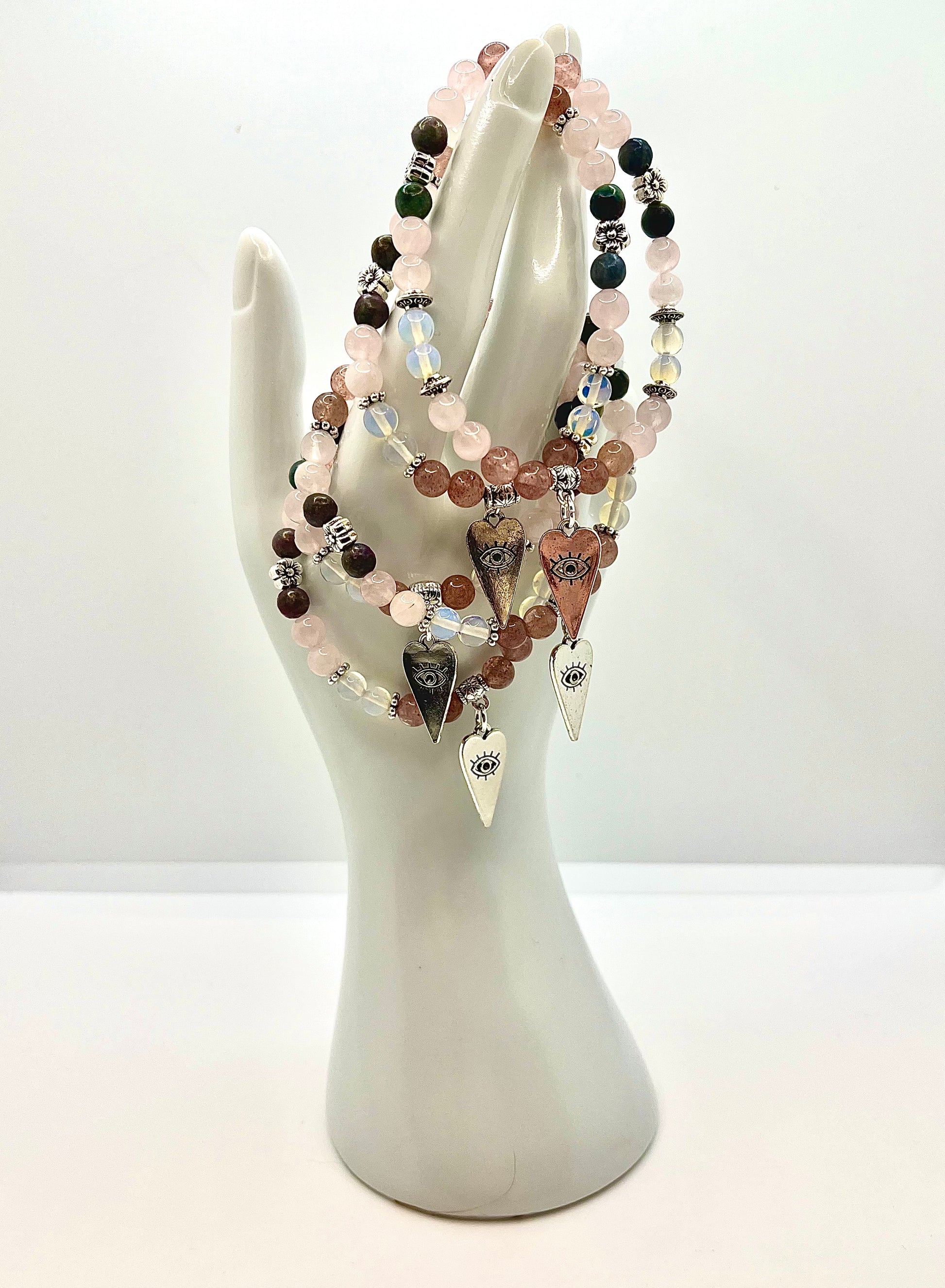 Hand statue with several LOVE ME bracelets draped on it