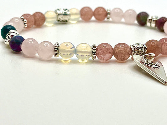 Closeup of LOVE ME bracelet focused on 6mm rose quartz, opalite and strawberry quartz beads