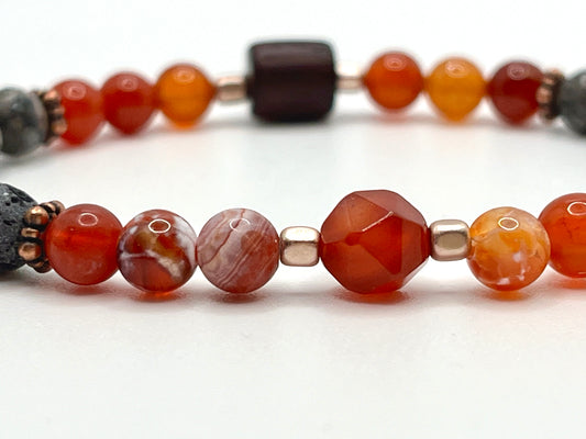 Closeup of bracelet, faceted carnelian stone, hematite, fire agate beads